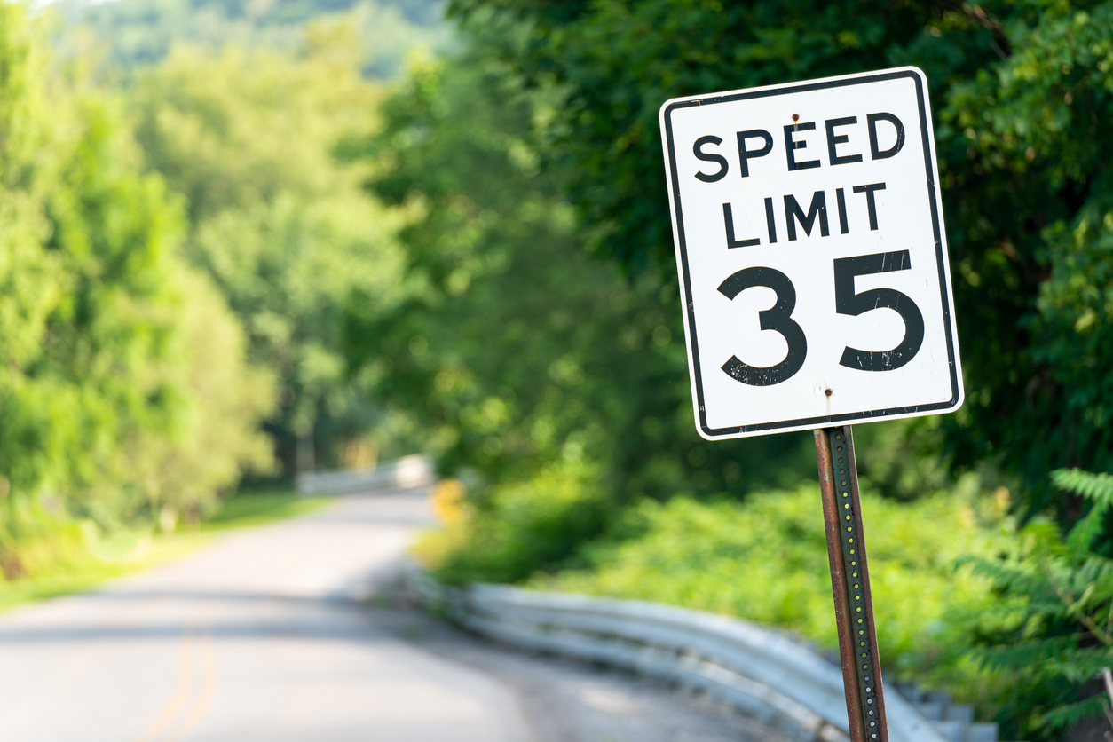 Speed limit sign showing the number 35 on a rural road